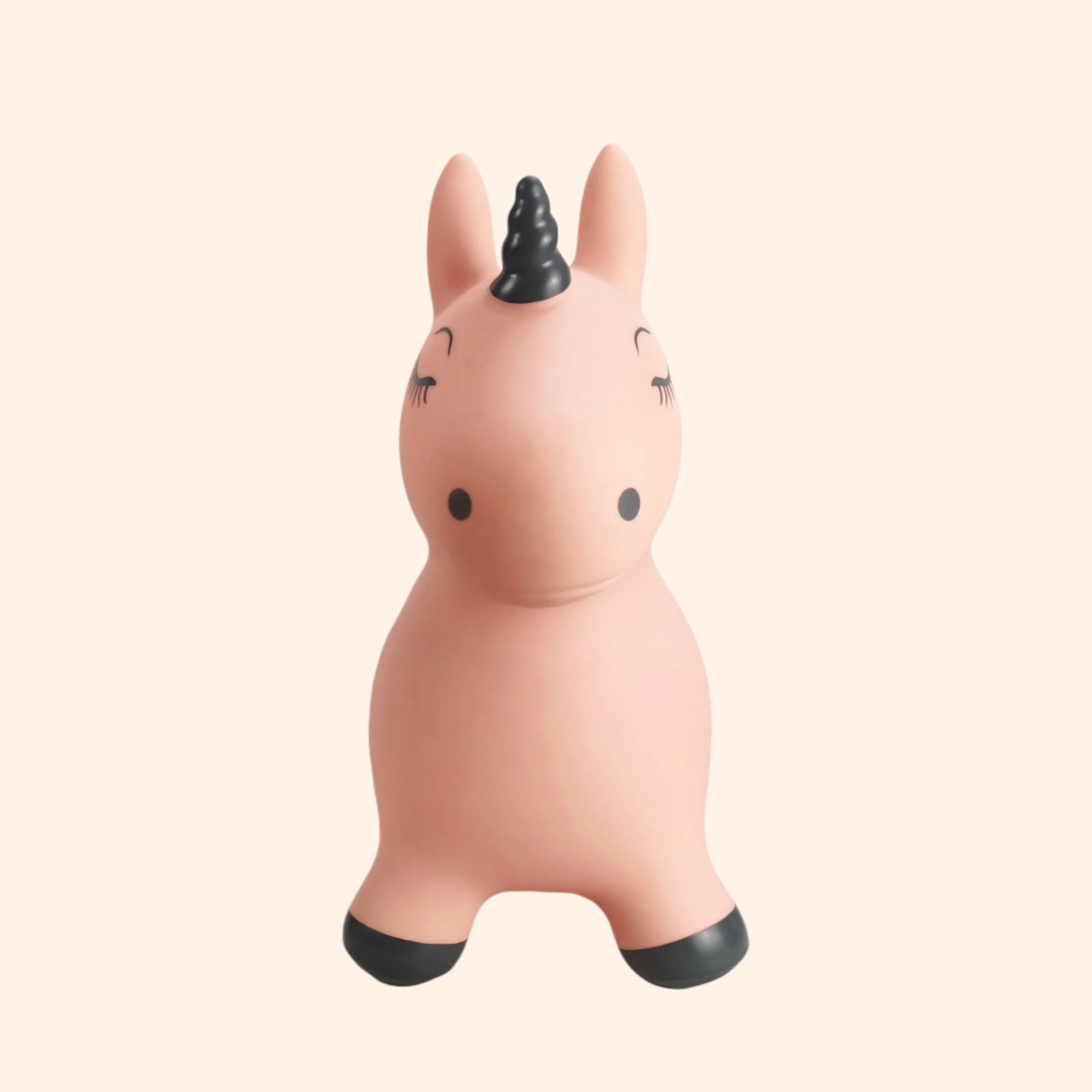 Luna the Unicorn – a soft pink inflatable jumping toy with a black horn and golden star, front-facing view.