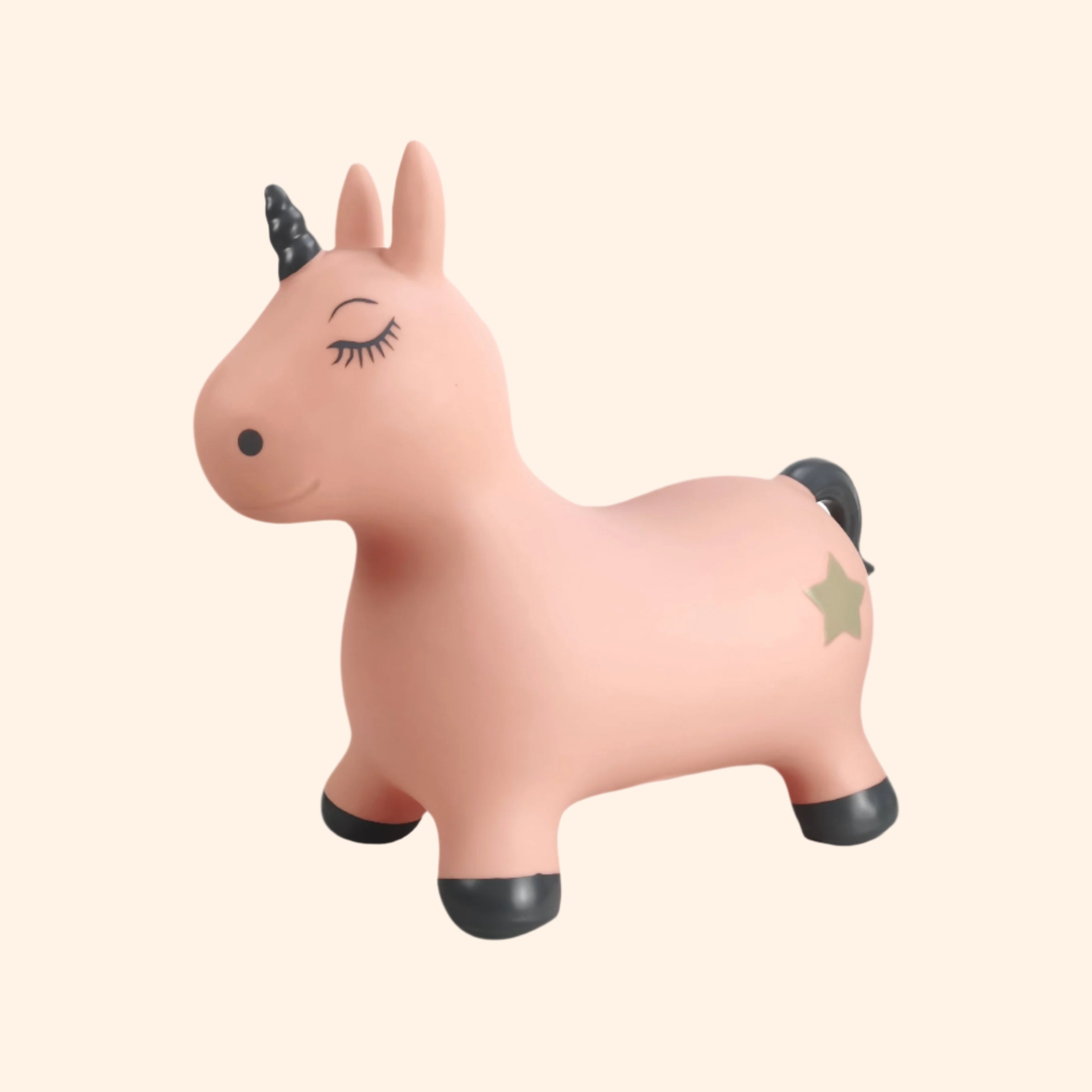 Luna the Unicorn – a soft pink inflatable jumping animal with a black horn, black hooves, and a small golden star on its side. Designed for toddlers and young children to bounce and play.